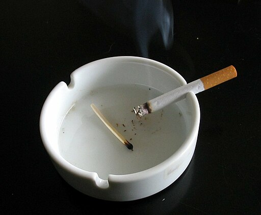 Cigarette in white ashtray