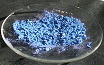 blue powder on a watch glass