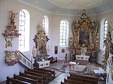 The interior of the church with baroque portals and ornate shrines