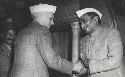 Rajendra Prasad shaking hands with Jawaharlal Nehru after signing the Constitution in 1950