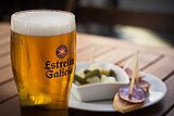 A large Estrella Galicia beer served alongside tapas in Santiago de Compostela