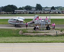 FAA tower team in pink remotely managing departures in 2011 FAA Oshkosh Tower team.jpg