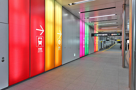 Color-coded wall paneling helps passengers inside the Tokyo Metro Fukutoshin Line's Shibuya Station to navigate passages to connecting rail lines. Shibuya is the fourth busiest station on the Tokyo Metro network and a major interchange with Tokyu, Keio, and JR East trains. Fukutoshin Line Shibuya Station 002.JPG