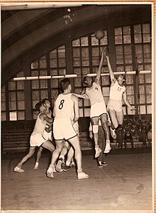 Israel vs Philippines, 1952 Olympics. Zacharia Ofri (#4) tipping off the ball. Israel vs Philippines 1952 Olympics.jpg