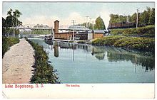 A view, sometime before 1911, looking south over the Morris Canal to the first DL&W station at Landing In the background is Landing Road Bridge. Lake Hopatcong prior to 1911.jpg