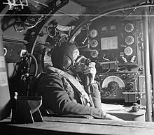 Flying Officer R.W. Stewart, a wireless operator on a Lancaster of No. 57 Squadron based at RAF Scampton speaking to the pilot from his position in front of the Marconi T1154/R1155 transmitter/receiver set Lancaster wireless operator WWII IWM CH 8790.jpg