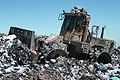 Landfill compacting machine in operation.