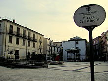 Piazza Celestino V, già Piazza Concezione. 
La pavimentazione della piazza è decorata in modo da ricordare la planimetria delle abitazioni distrutte nel bombardamento.