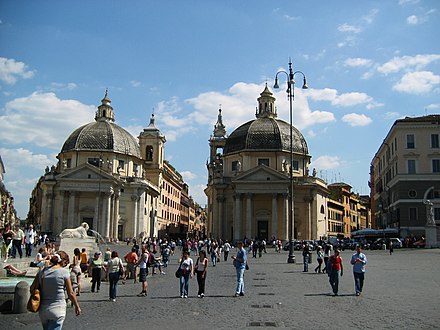 The "twin" churches of Santa Maria di Montesanto (left) and Santa Maria dei Miracoli (right), seen from Piazza del Popolo. Between the two churches Via del Corso starts. Although very similar, differences can be seen in this image in the two small belfries and in the two domes (noticeable from the number of windows in the tympanum of each church).