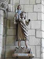 Photographie d'une statue de saint portant un enfant sur son épaule