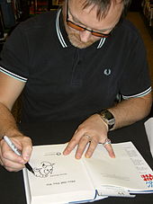 Simon Donald drawing Sid the Sexist in a copy of his book, Him off the Viz, November 2010 Simon Donald 001.jpg