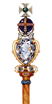 Gold rod surmounted by a large diamond, itself supporting a large round amethyst, on top of which is a cross made of diamonds with an emerald at its centre.