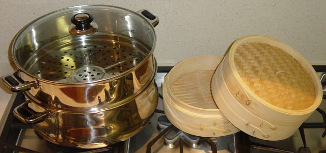 Two types of steaming vessels, metal and wood with bamboo