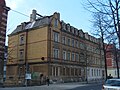 Double apartment building in open development and side gate entrance