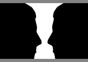 English: Two silhouette profiles or a white va...