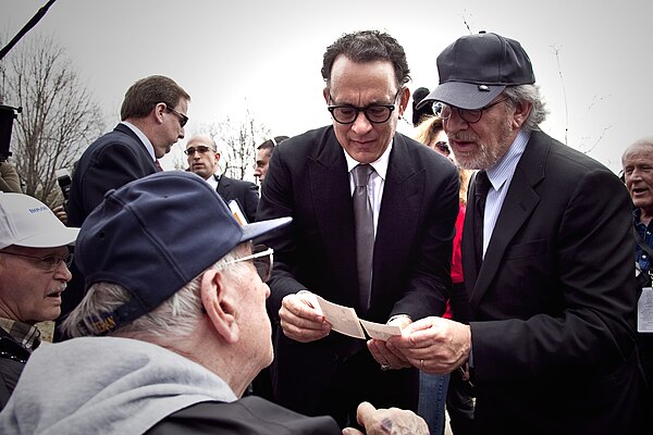 Executive producers Tom Hanks and Stephen Spielberg talk with veterans of the World War II Pacific theater March 11 after a ceremony honoring the men 