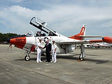 CAPT Dan Ouimette, Commodore of TRAWING ONE, and CDR Paul Shankland, CO of VT-9, present the last T-2C to make a carrier arrested landing to the National Naval Aviation Museum at NAS Pensacola. US Navy 040409-N-1914G-001 Capt. Daniel Ouimette, Commodore, Training Air Wing One (TW-1), left, presents the last T-2C Buckeye.jpg
