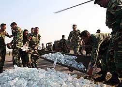 Bangladesh Army soldiers unload a shipment of bottled water for cyclone victims.