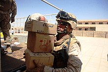 A corpsman with Delta Co., 4th Light Armored Reconnaissance Battalion, delivers medical supplies to be issued to more than 200 Iraqis during a cooperative medical engagement in Akashat. US Navy 080723-M-6065T-003 Hospital Corpsman 2nd Class Doug A. Augustine, a corpsman with Delta Co., 4th Light Armored Reconnaissance Battalion, delivers medical supplies.jpg