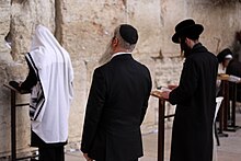 Praying at the Western Wall Western Wall, Jerusalem, (16037897867).jpg