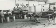 Neri and Bonacini workshop in September 1963. An ASA 1000 GTC is visible on the lift at center of image. 1963 ASA 1000 GTC at Neri and Bonacini, Modena.png