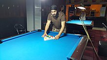 220px A person setting the cue balls