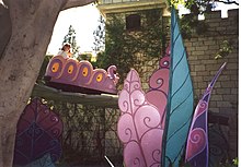 A guest riding the Alice in Wonderland ride in 1996. AlicesRide wb.jpg