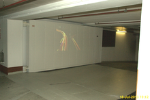 Large fire door, sealing a fallout and air raid shelter inside the basement parking garage of a hotel in Germany. Big german fire door 1.png