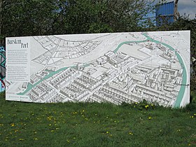 Information board by the Trent and Mersey Canal, at the former junction with the Burslem Branch Canal. The artwork shows how the Branch Canal and surrounding areas would have looked shortly before the breach in 1961. Burslem Port information board.jpg