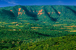 Hills covered with lush vegetation and some tree-less brown patches