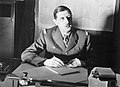 Commander of Free French Forces General Charles de Gaulle seated at his desk in London during the Second World War. D1973.jpg
