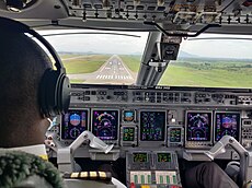 An Embraer 145 on final approach to runway 22