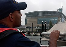 A U.S. Coast Guardsman patrols the waters adjacent to the FleetCenter DNC 1076048.jpg