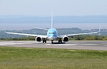 The upward tilt of the wings and tailplane of an aircraft, as seen on this Boeing 737, is called dihedral angle. Dihedral on a TUI Boeing 737-800 (G-TAWJ) taxying for take off at Bristol Airport, England 14May2019.jpg