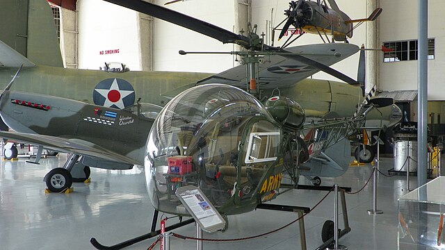 Fantasy of Flight's Bell 47G displayed in foreground, Supermarine Spitfire Mk.16 behind, and Cierva C.30A autogyro in the upper right. The B-26 stands