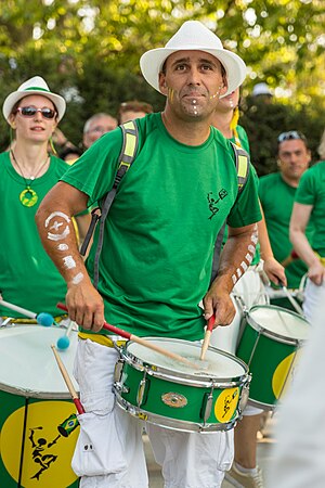 Group Tribal Percussion marching in Annecy (France) playing Brazilian percussion: the batucada.