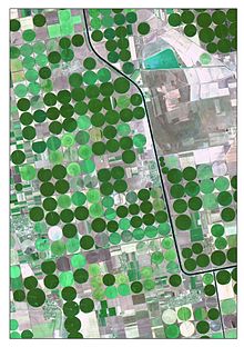 The picture is a satellite image of irrigated crops and Kahov irrigation canal. It was captured on 7 August 2015 by Landsat 8 (OLI). The image is created as a True Color Composite, where R – Red Band (0.64 - 0.67 μm), G – Green Band (0.53 - 0.59 μm) and B – Blue Band (0.45 - 0.51 μm). This band combination is suitable for crop monitoring. For emphasizing characteristics, the image was pan-sharpened by panchromatic band. Nonlinear adaptive procedure of contrasting was also applied.