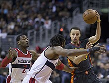 Curry about to pass while being guarded by John Wall and Nenê of the Washington Wizards. Curry averaged 7.7 assists per game during the 2014–15 regular season, good enough for sixth-best in the league.[66]