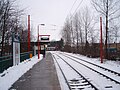 The view west along Platform 2, as a bus crosses the Brunton Lane level crossing 2 January 2010