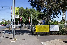 A large yellow sign next to the Cramer Street, Preston level crossing indicating that it will be removed.