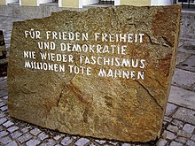 Outside the building in Braunau am Inn, Austria, where Hitler was born, is a memorial stone placed as a reminder of the horrors of World War II. The inscription translates as:
For peace, freedom
and democracy
never again fascism
millions of dead warn [us] Mahnstein.JPG