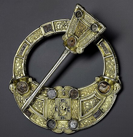 The Hunterston Brooch, Irish c. 700, is cast in silver, mounted with gold, silver and amber decoration.