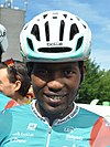 closeup of man wearing a racing helmet and smiling broadly