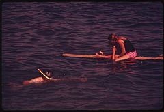 A snorkeler and surfer at the beach in September 1974