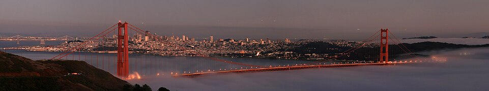 Panorama of San Francisco with two bridges (Western section of Bay Bridge in the left background), Coit Tower (in background to the left of north tower), and Fort Mason (on the San Francisco waterfront in the background behind the north tower) from Marin