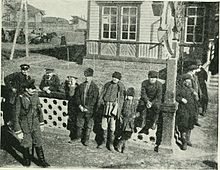 Siberian peasants watching a train at a station, 1902 Siberian peasants watching a train at a station, (1902).jpg