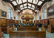 Proceedings in the Supreme Court, which moved to its modern home at Middlesex Guildhall in 2009, are web-streamed live, and judges no longer wear wigs. Supreme Court of the United Kingdom, Court 1 Interior, London, UK - Diliff.jpg