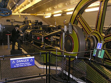 A stationary steam engine, preserved at Tower Bridge in London. This is one of two tandem cross-compound hydraulic pumping engines formerly used to raise and lower the bridge. Tower.bridge.99.machinery.london.arp.jpg