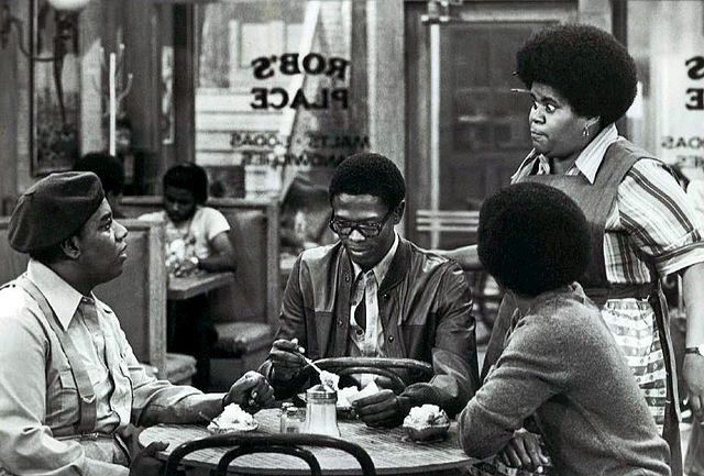 Seated, L-R: Fred Berry, Ernest Lee Thomas, and Haywood Nelson (back to camera). Standing: Shirley Hemphill.