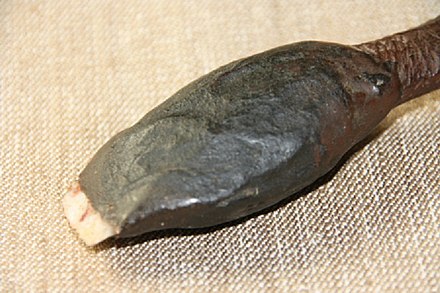 A sharp stone attached to the end of the handle